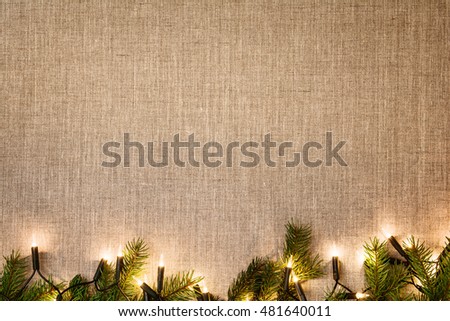 Christmas decoration background over linen background. Horizontal photo taken from above, top view with copy space for text and other web or print design elements.