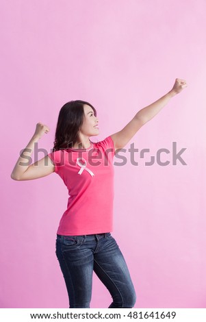 Happy Woman with pink ribbon and show strong biceps, great for prevention breast cancer concept