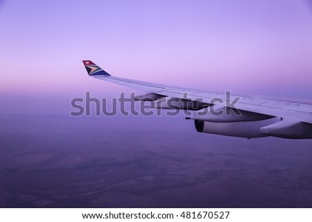 An South African Airways airplane's wing as seen from inside the airplane.  Royalty-Free Stock Photo #481670527