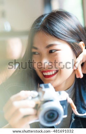 Portrait of asian beautiful young hipster woman with mirrorless camera in cafe, Retro lifestyle
