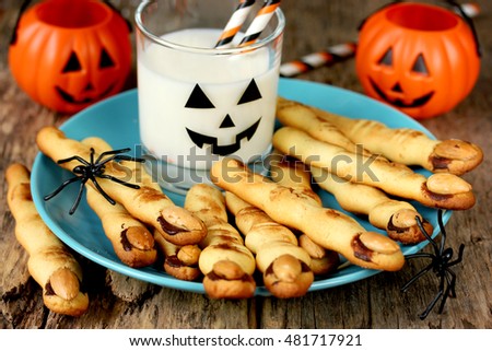 Halloween witch fingers cookies. Homemade cookies in the form of terrible human fingers decoration almond nail for treat kids for Halloween party selective focus