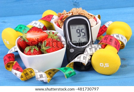Glucose meter with result of measurement sugar level, healthy food, dumbbells for fitness and tape measure, concept of diabetes, slimming, healthy lifestyle Royalty-Free Stock Photo #481730797