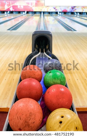 Multi colored bowling balls on base