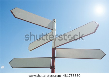 Blank sign post against blue sky