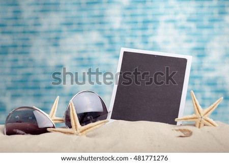 photo frames on the beach with seashells around