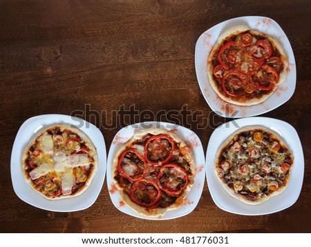 Pizza on a wooden background with free field
