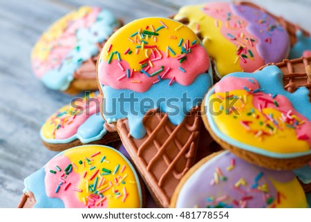 Pile of decorated cookies. Frosting of bright colors. Make a surprise for kids. Treats with sugar icing.