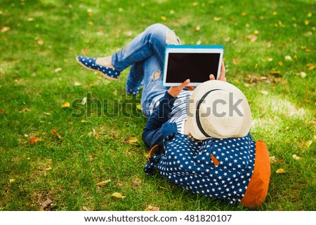 young girl with laptop outdoors