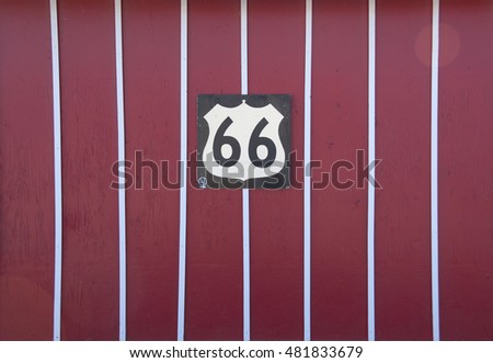 Route 66 sign on red wall, Seligman, Arizona, USA