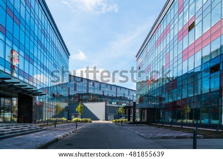 Empty courtyard of a modern office center, a new glass commerce building, empty parking lots, bright day Royalty-Free Stock Photo #481855639