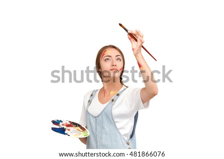pretty young artist holding a palette and brushes. creation