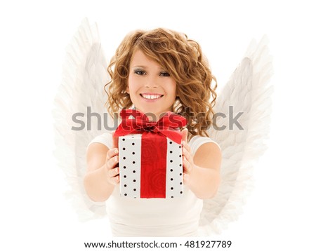 people, holidays, christmas, birthday and religious concept - happy young woman with angel wings holding gift box over white background