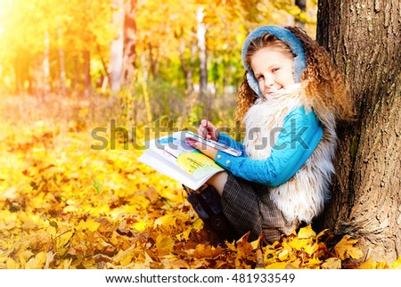 Beautiful Girl with Red Curly Hair Drawing Picture in the Autumn Park - Sunny Day - Autumn Fall