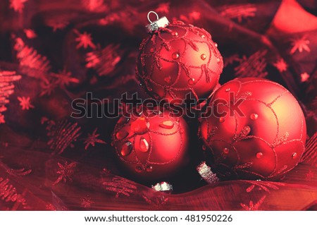 Christmas balls on red table cloth.