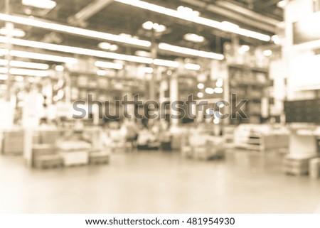 Blurred image large furniture warehouse with row of aisles and bins from floor to ceiling. Defocused background industrial storehouse interior aisle. Inventory, logistic, export concept.Vintage filter