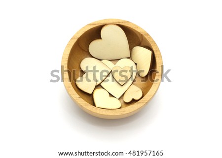 Isolated wooden bowl with wooden heart shape, love symbol inside on  white background