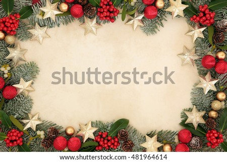 Christmas background border with gold star and red bauble decorations, holly, mistletoe, snow covered spruce fir and pine cones on old parchment paper.