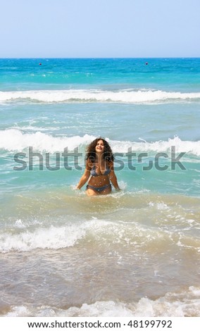 Pretty brunette dirty girl in blue sea.