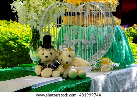 Teddy bears, hearts, flowers, books on the table.