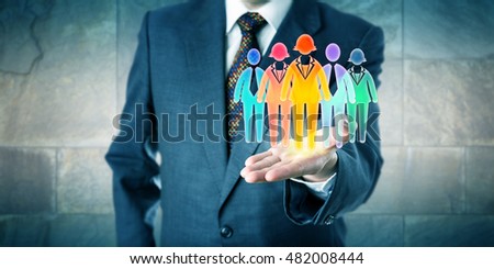 White collar manager presenting a work team of five multicolored worker icons in open palm of his left hand. Business concept for team building, diversity inclusion culture and staffing solutions. Royalty-Free Stock Photo #482008444
