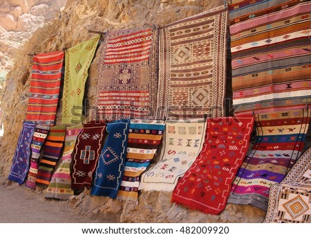 Colourful hand woven woollen rugs displayed for sale at Todgha Gorge in Morocco. Royalty-Free Stock Photo #482009920