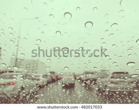 Water drops on blurred traffic road background.Style vintage tone.