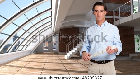 Young man holding a rolled-up plan in a empty loft
