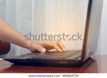 hand typing keyboard on brown table in office