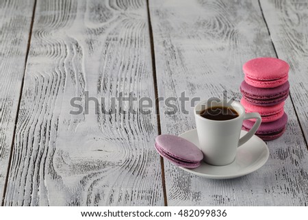 Coffee, macaroons and cream on a white table