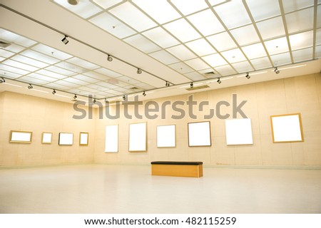 Gallery interior with empty frame on wall 