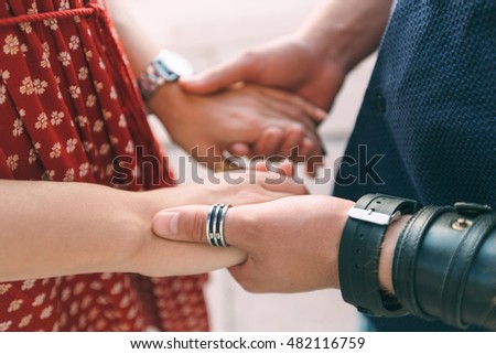 Loving couple holding hands, close-up. Hands together, man and woman.