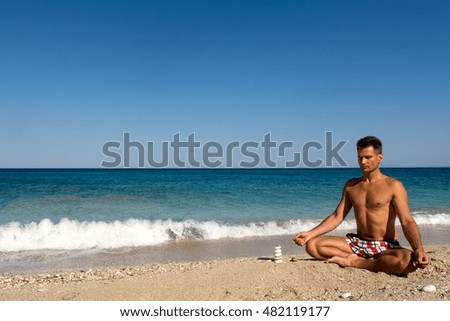 Adult male meditation practice in the morning on the beach, Lefkada island, Greece
