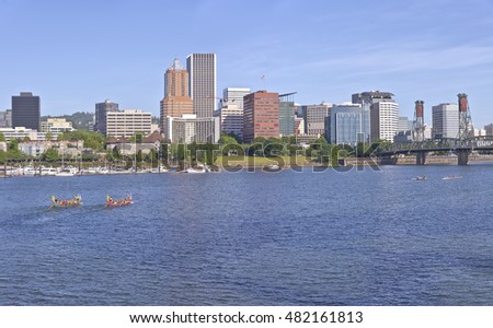 Portland Oregon skyline and dragon boats rowing in morning light.