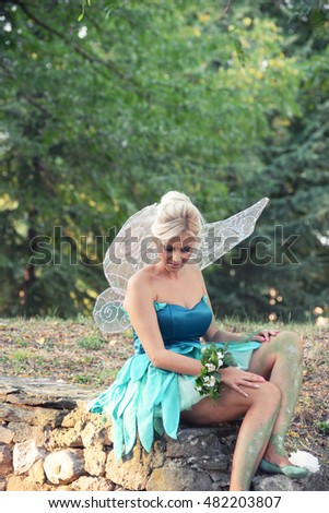 Tinker Bell. Girl dressed as a fairy tale of Peter Pan