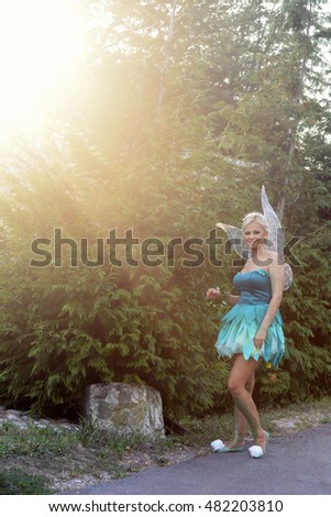 Tinker Bell. Girl dressed as a fairy tale of Peter Pan