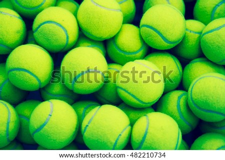 lot of bright yellow tennis balls as a background