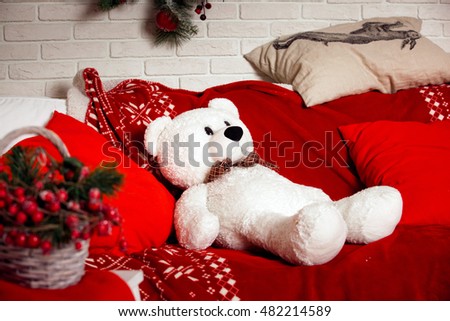 Christmas background with red sofa and white bear toy sitting