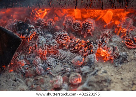 Fire and smoke in the fireplace, burning and smoldering lumps of coal.
Christmas symbol.