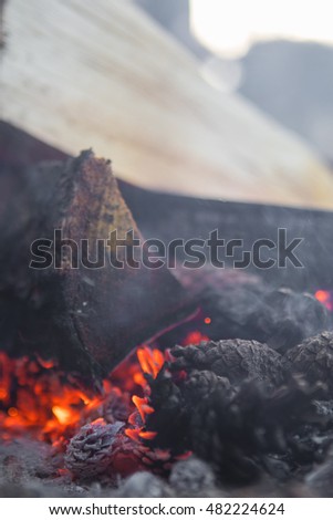 Fire and smoke in the fireplace, burning and smoldering lumps of coal.
Christmas symbol.