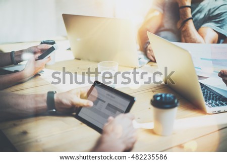 Young Business Team Meeting Brainstorm Process.Coworkers Working Startup Online Concept.People Using Modern Electronics Gadgets.Creative Hipsters Work New Project Wood Table.Blurred Background