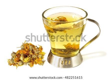Useful herbal tea with calendula in a cup and handful of dried marigold isolated on white background