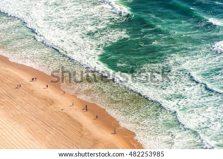 Aerial view from above of ocean, sea beach and water waves with people on sand shore with emphasis of the scale of people and nature. Surfers Paradise, Gold Coast, Queensland Australia Royalty-Free Stock Photo #482253985