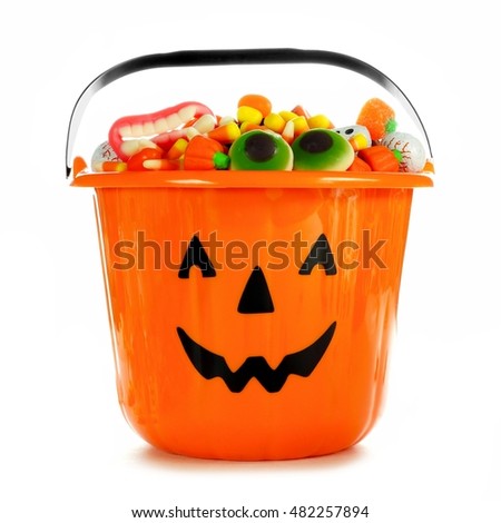 Halloween Jack o Lantern candy collector filled with candy over a white background