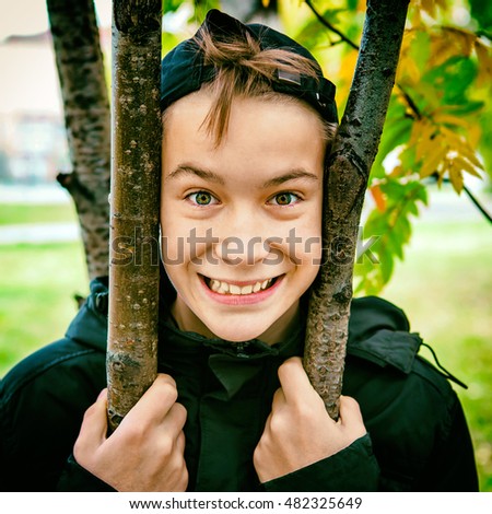 Toned Photo of Happy Kid Portrait in the Autumn Park