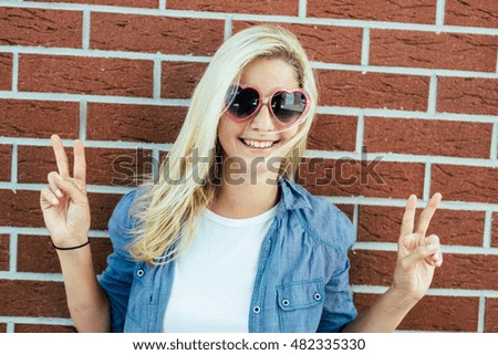 Cute blonde woman posing outdoor