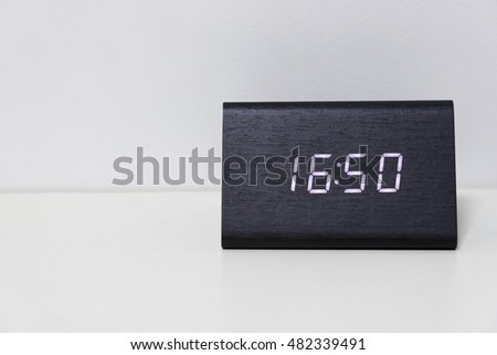 Black digital clock on a white background showing time 16:50 (sixteen hours fifty minutes)