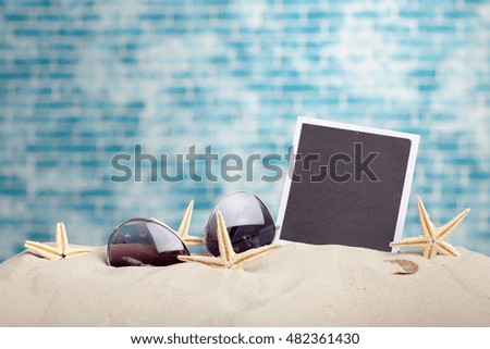 photo frames on the beach with seashells around