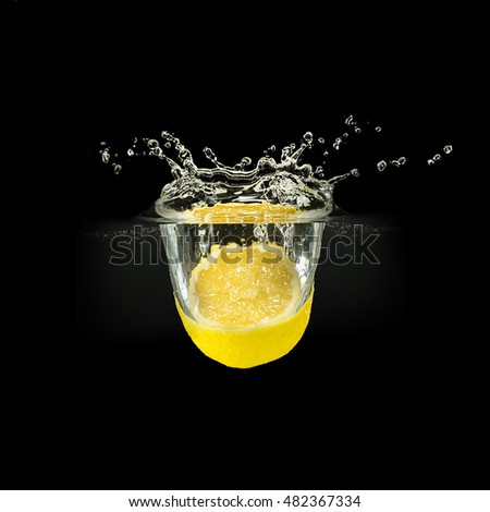 Fresh fruits falling in water with splash on black background.