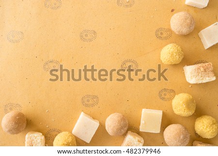 Diwali prayer celebration preparation  with sweets and copy space background on handmade paper with Indian motifs 
