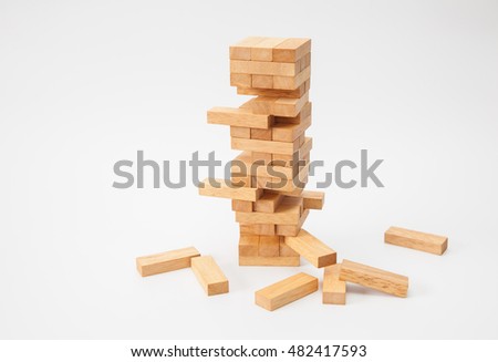 Wood block tower game on white background Royalty-Free Stock Photo #482417593
